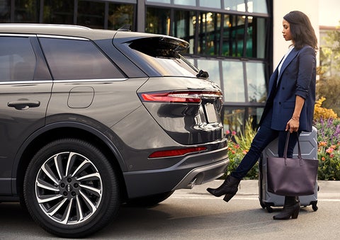 A woman with her hands full uses her foot to activate the available hands-free liftgate. | Maguire's Lincoln in Palmyra PA