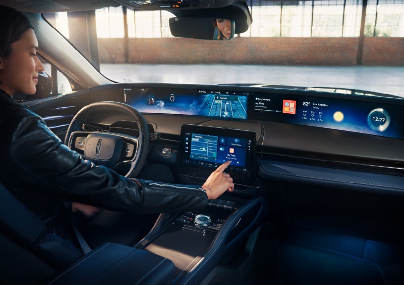 The driver of a 2024 Lincoln Nautilus® SUV interacts with the center touchscreen. | Maguire's Lincoln in Palmyra PA